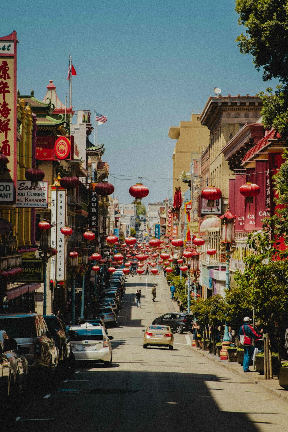 vehicles parked on china town during daytime
