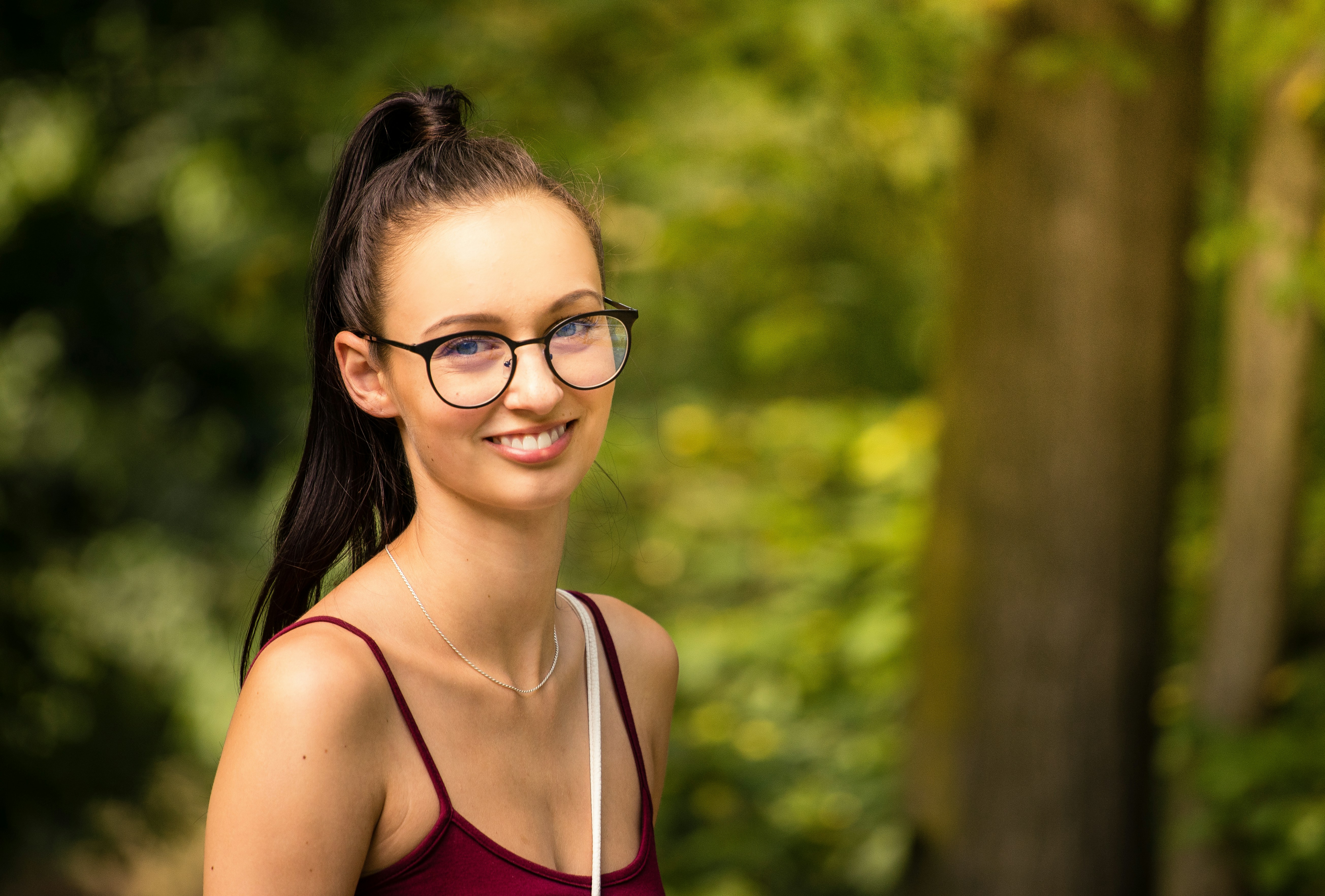 woman in red camisole smiling