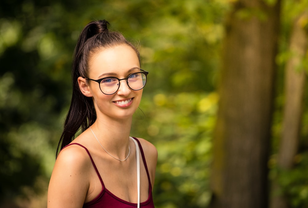 woman in red camisole smiling