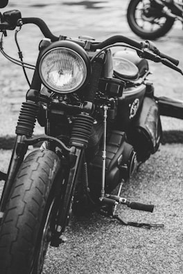 Side profile of a vintage motorcycle sharply contrasted with white background.