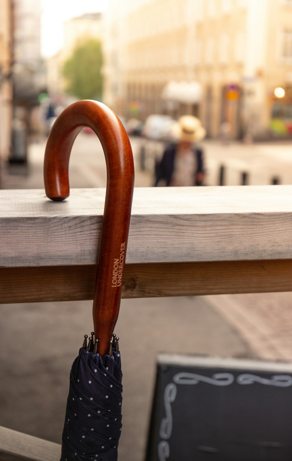 brown umbrella on brown wooden bench