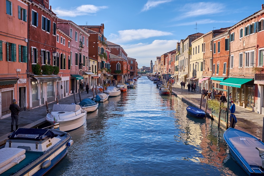 boats on canal near buildings