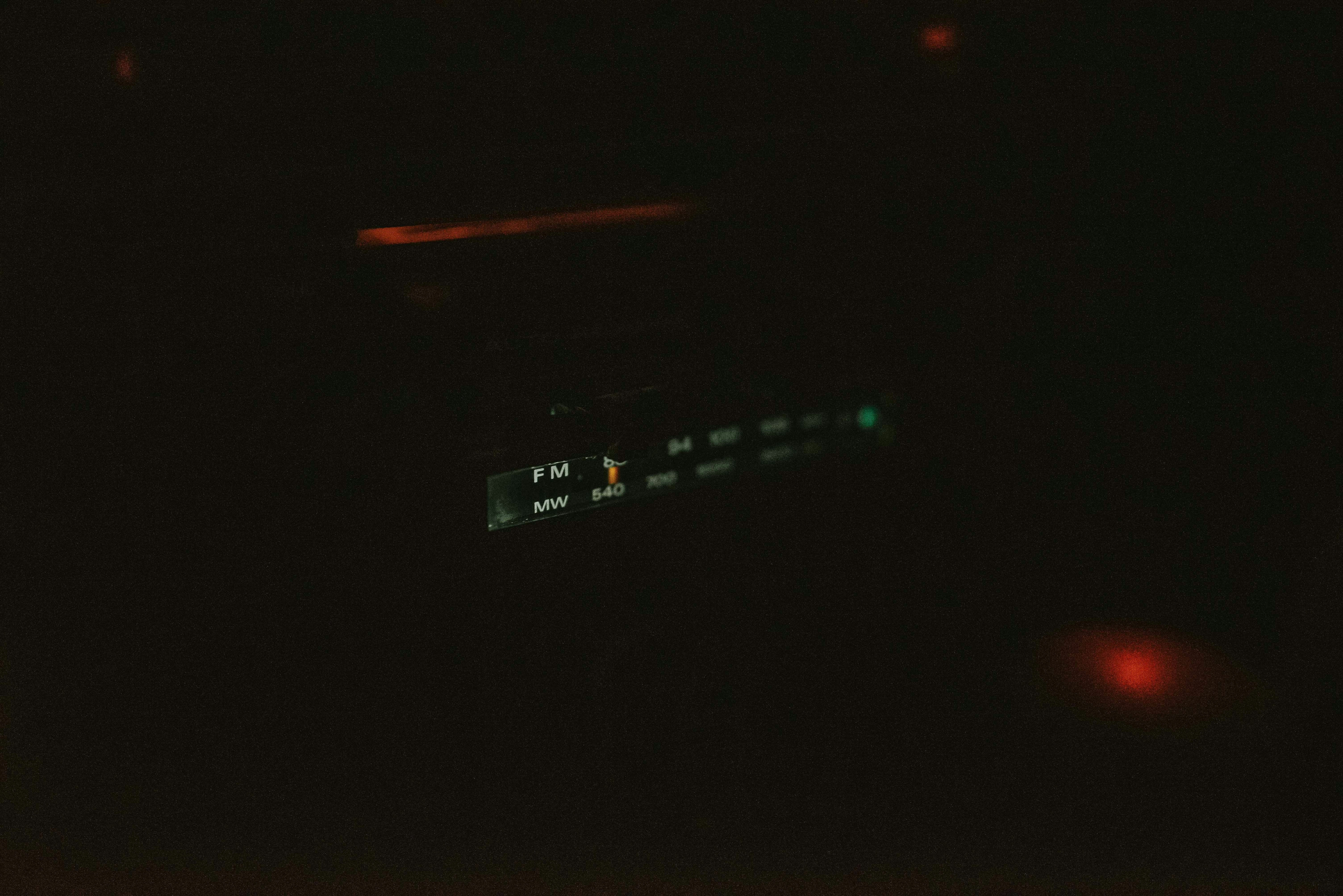 a close up of a clock in the dark