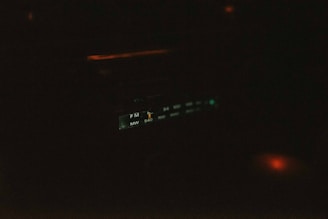 a close up of a clock in the dark