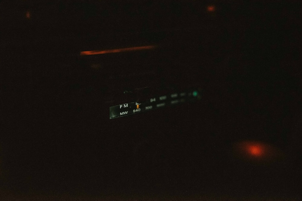 a close up of a clock in the dark