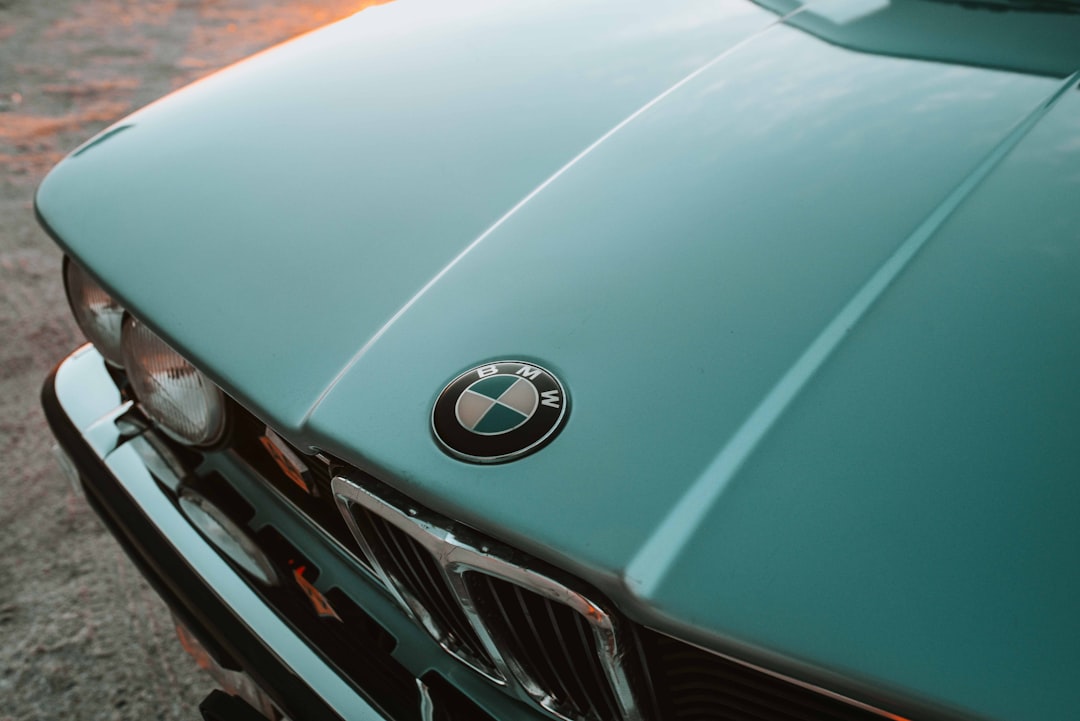 green BMW sedan during daytime