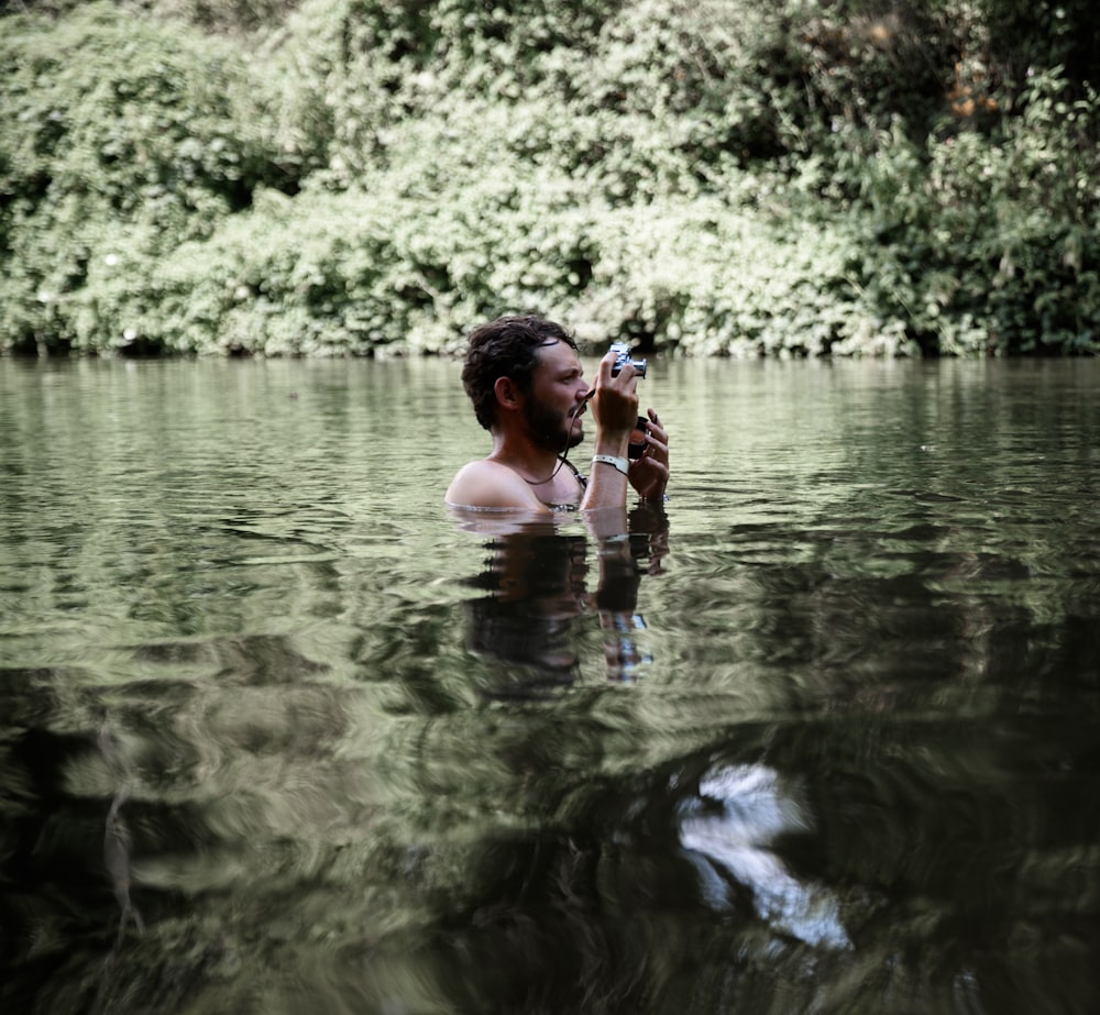 man taking photo on body water