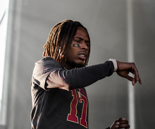 An artist mid-performance on stage
