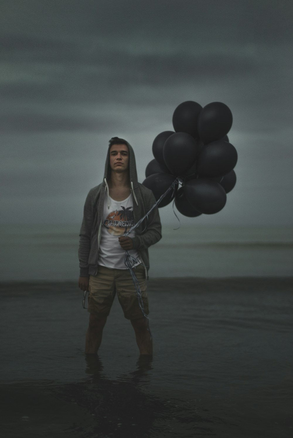 man holding balloons while on water