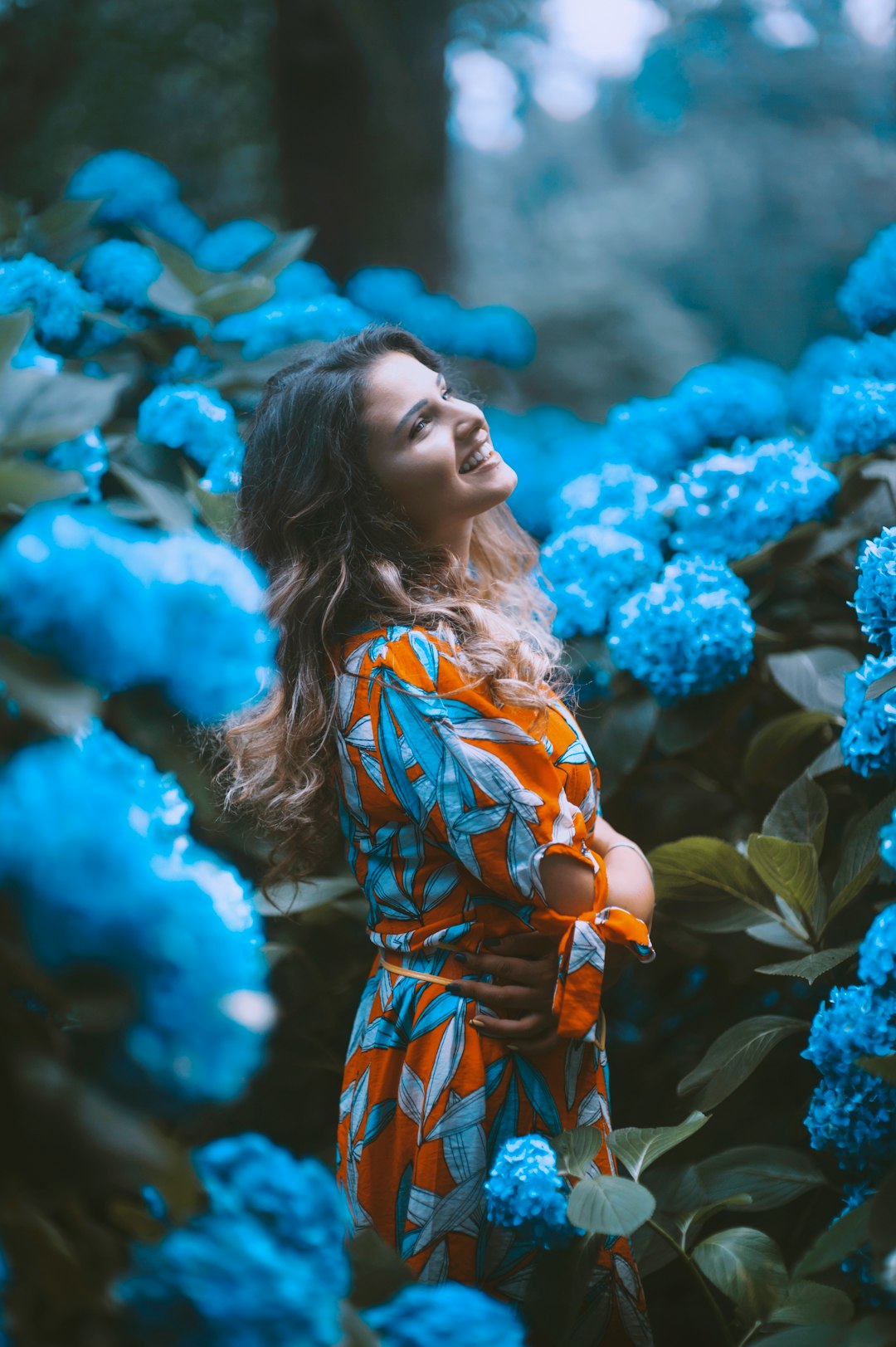 woman standing infront of flowers