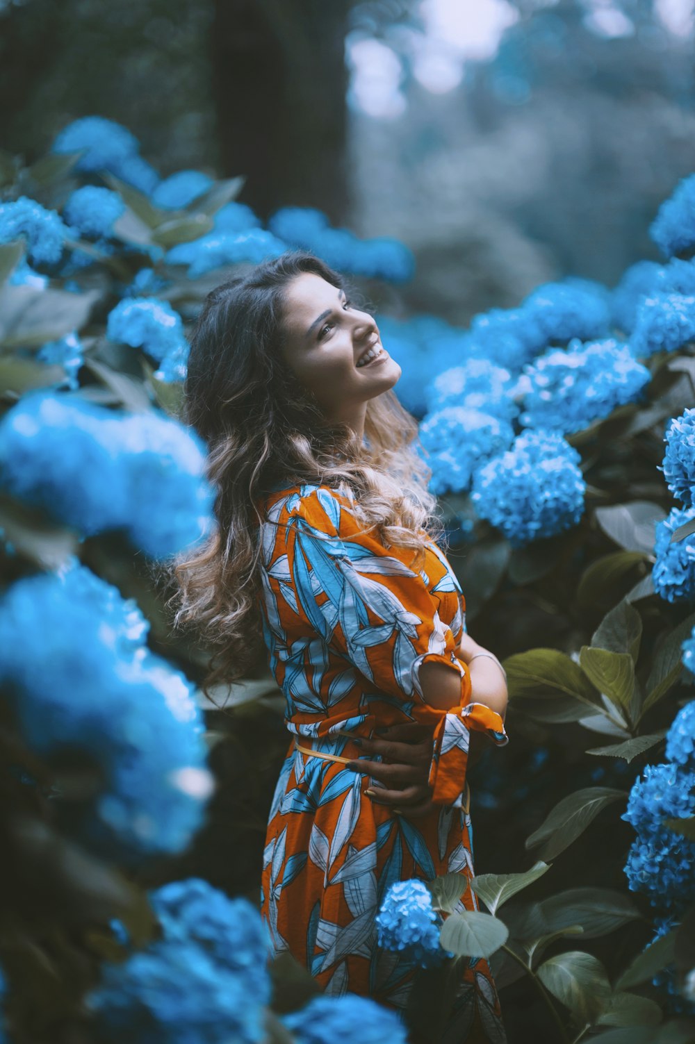 woman standing infront of flowers
