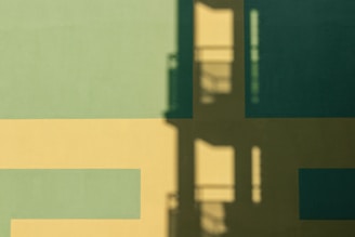 Asymmetrical composition featuring layered plantain green graphic shapes with shadows