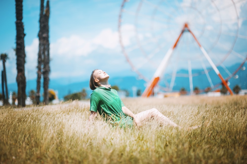 woman sitting on green grass