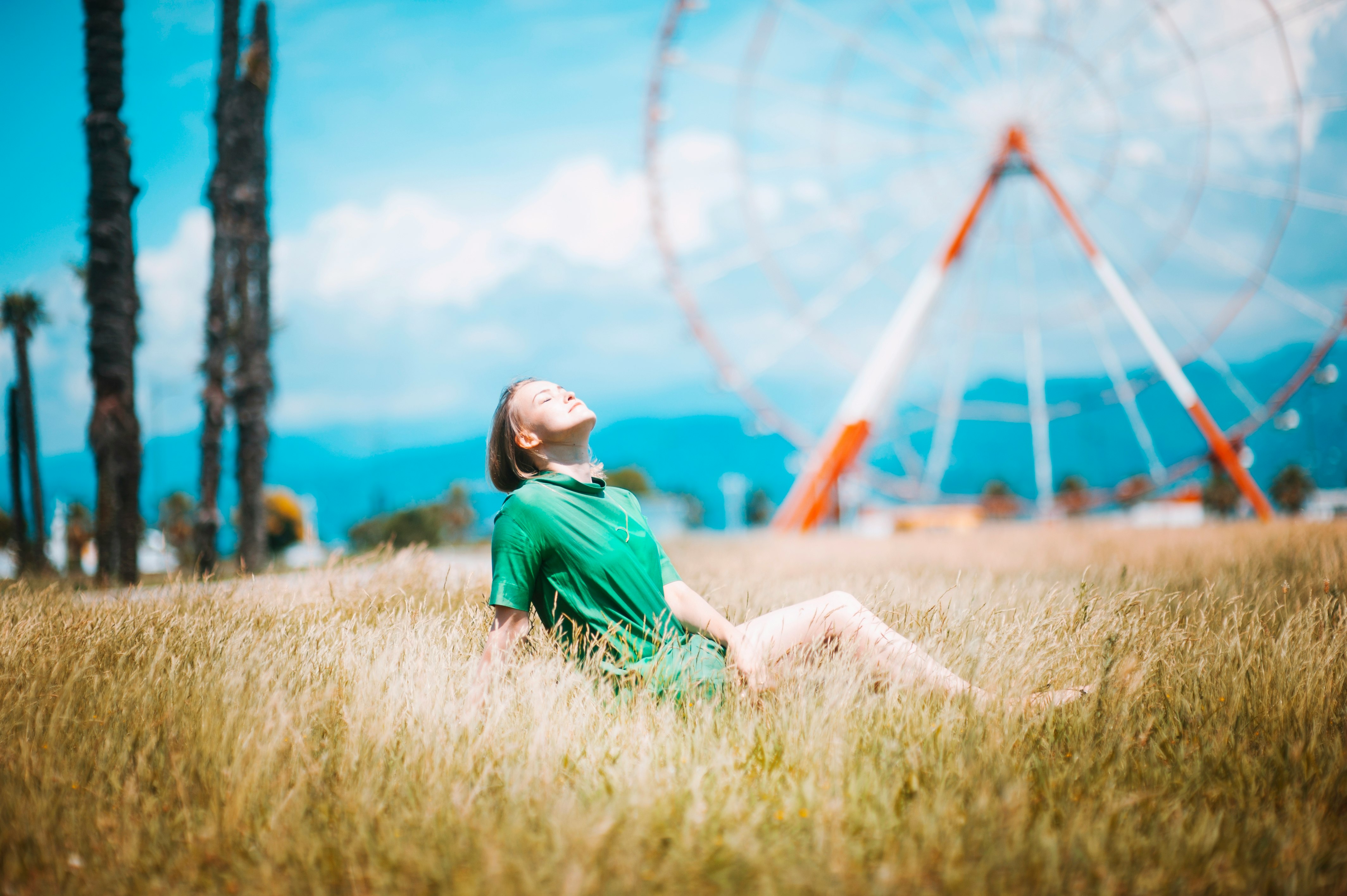 woman sitting on green grass