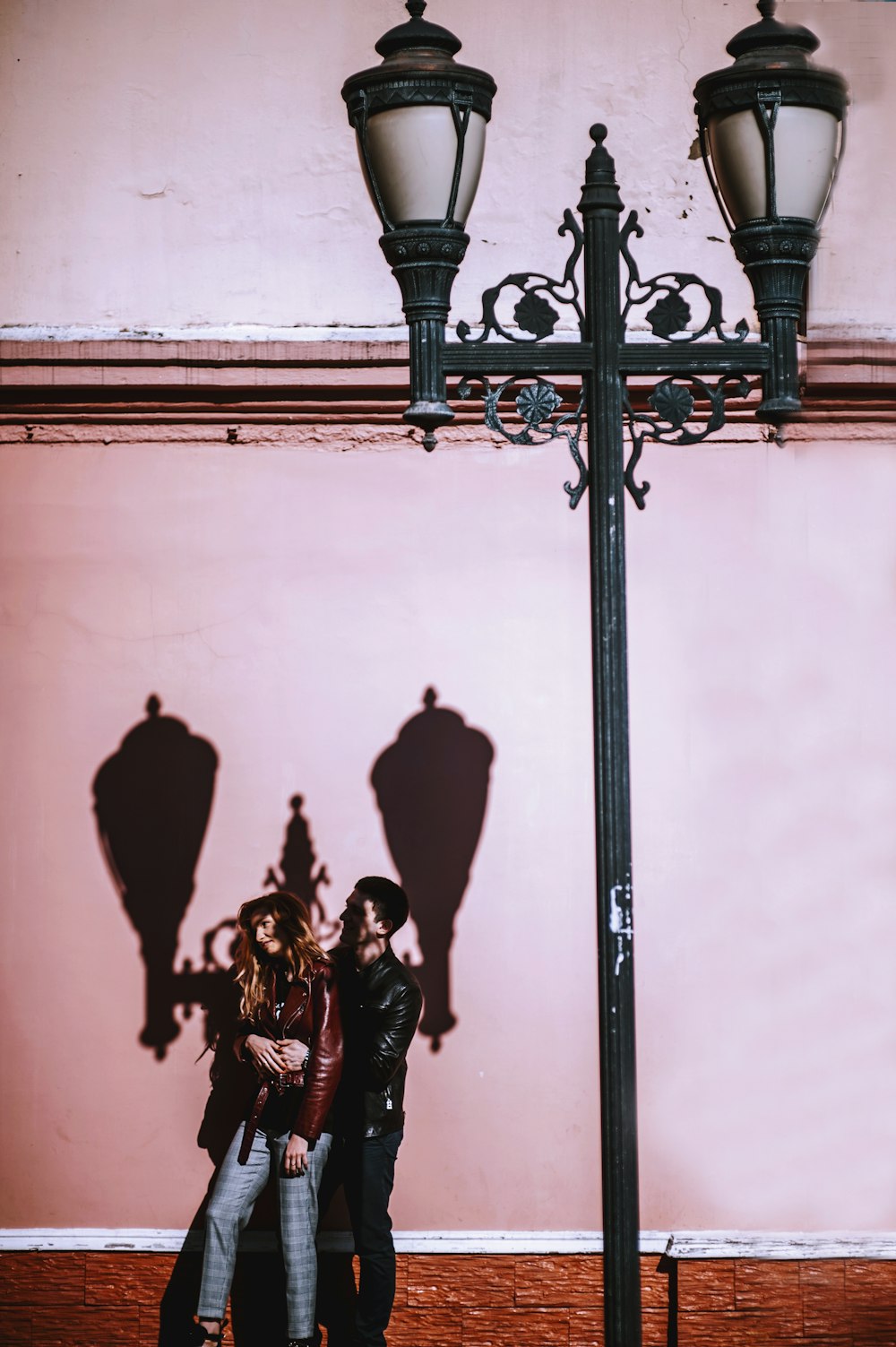 two person behind street lamp