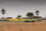A dynamic shot of a Formula 1 car speeding on a racetrack with blurred background.