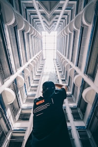 man in black T-shirt standing inside building