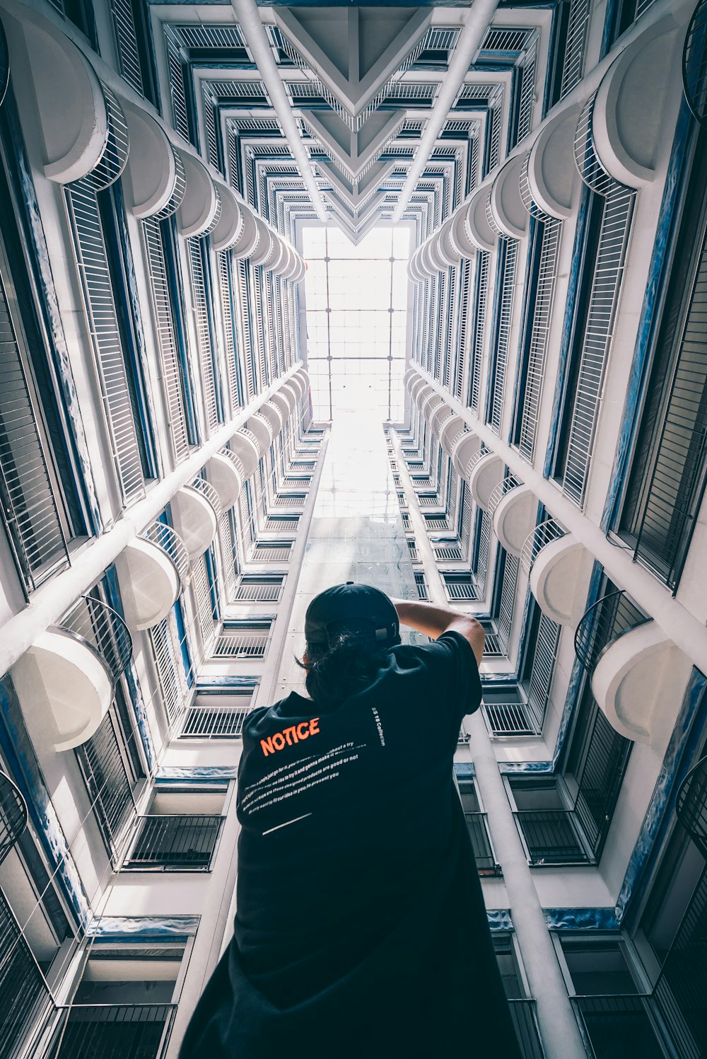 man in black T-shirt standing inside building