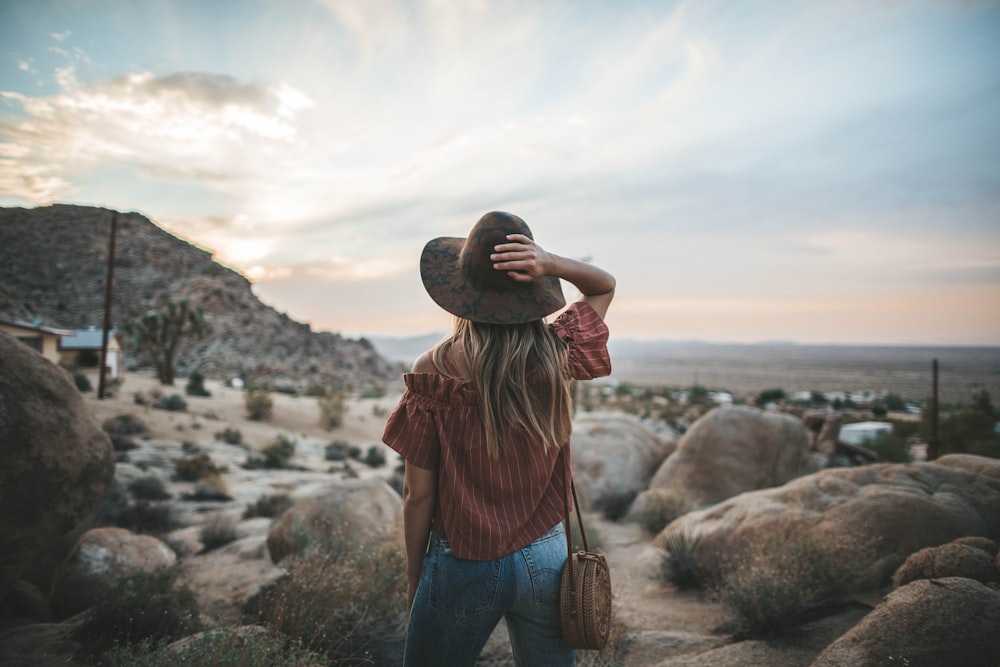 woman standing in front of stones during daytime