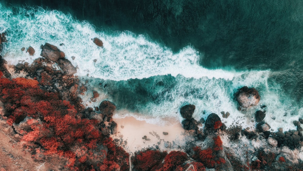 aerial photo of rock formation and sea waves