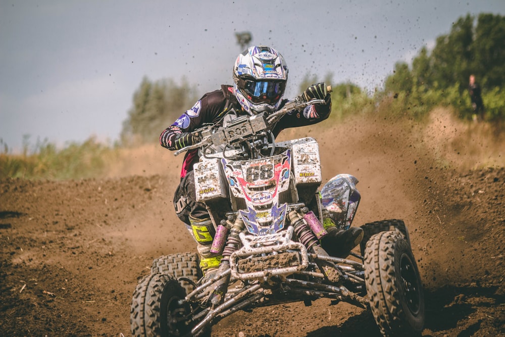 person riding blue all-terrain vehicle