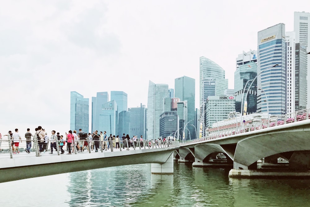 people waking on bridge during daytime