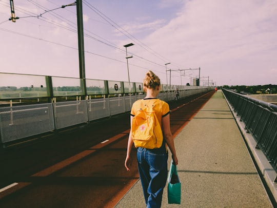 woman in yellow walking on street in Nijmegen Netherlands