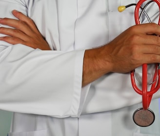 doctor holding red stethoscope