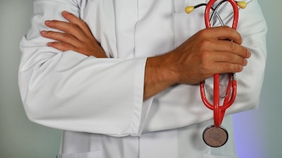 doctor holding red stethoscope