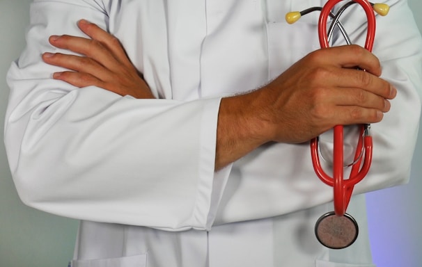 doctor holding red stethoscope