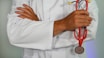 doctor holding red stethoscope