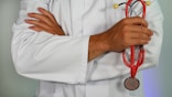 doctor holding red stethoscope