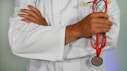 doctor holding red stethoscope