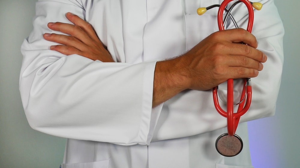 doctor holding red stethoscope