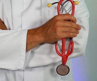 doctor holding red stethoscope