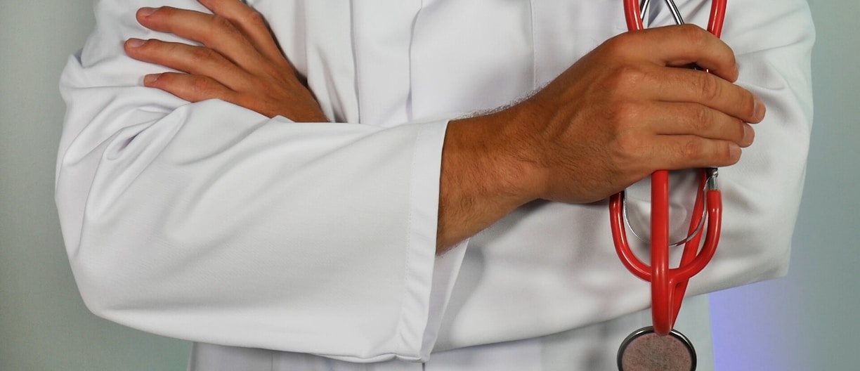 doctor holding red stethoscope