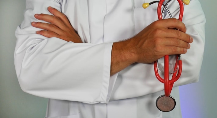 doctor holding red stethoscope