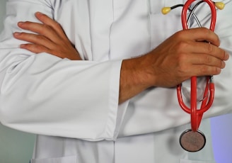 doctor holding red stethoscope