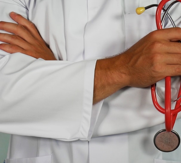 doctor holding red stethoscope