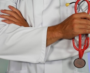 doctor holding red stethoscope