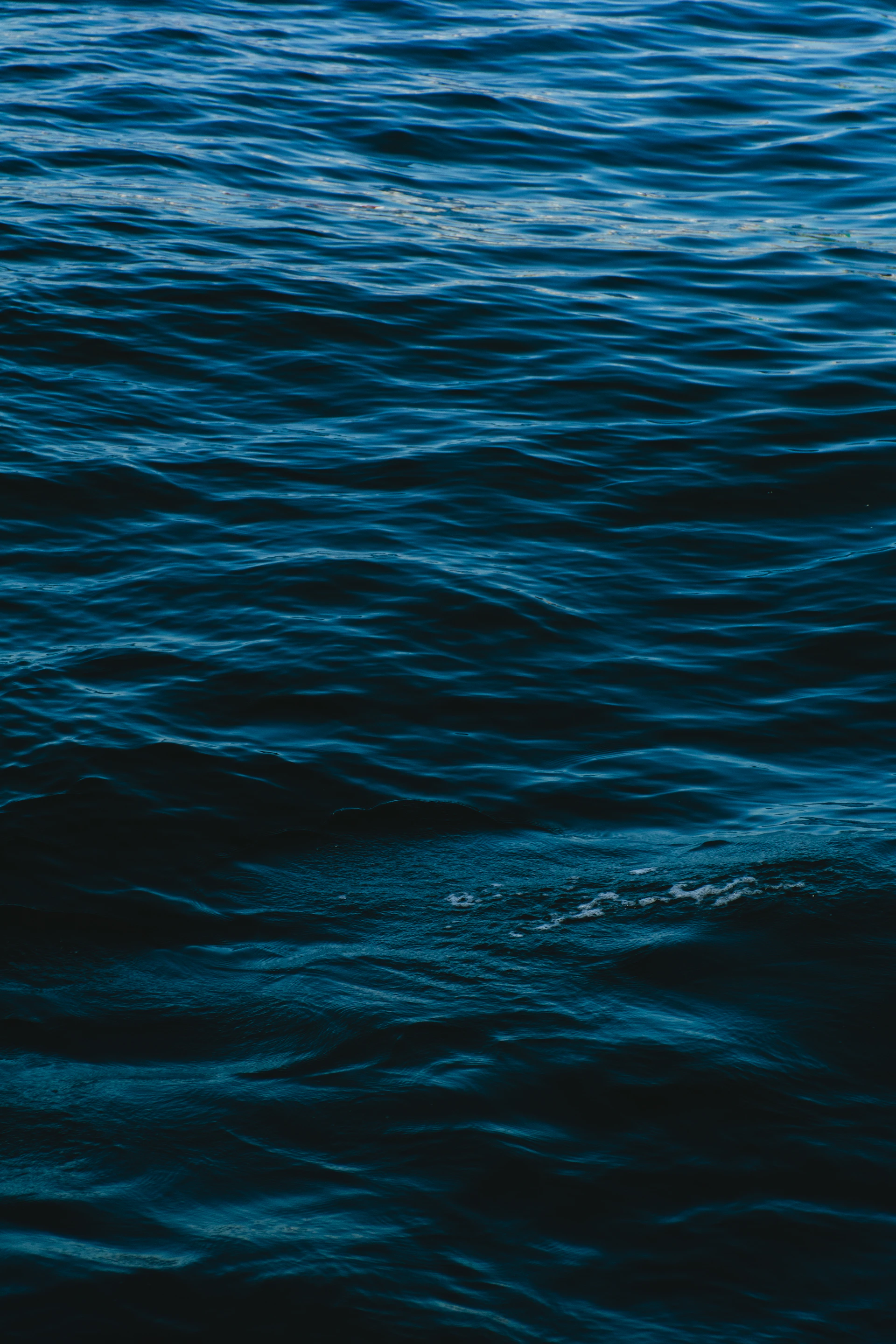 a man riding a surfboard on top of a body of water