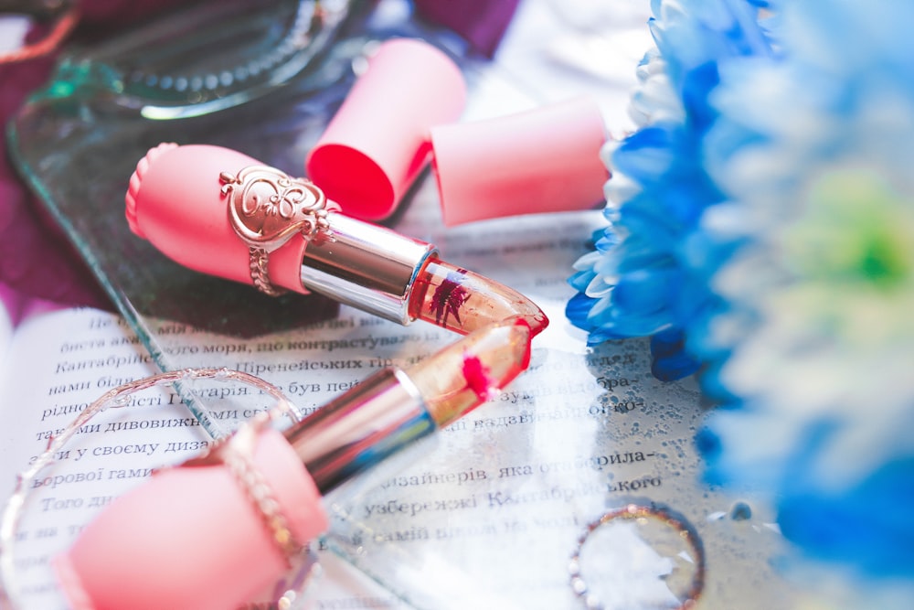 two pink lipsticks on table