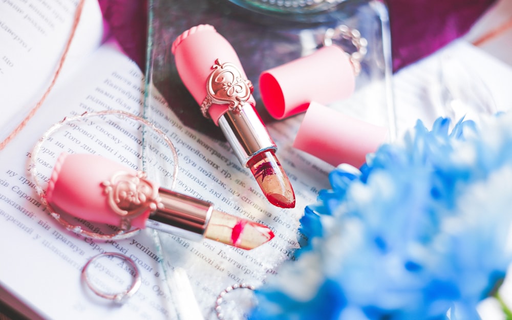 two pink lipsticks on gray paper