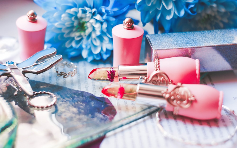 lipsticks beside gray box and bottles