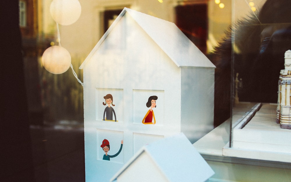 a window display of a house with people on it