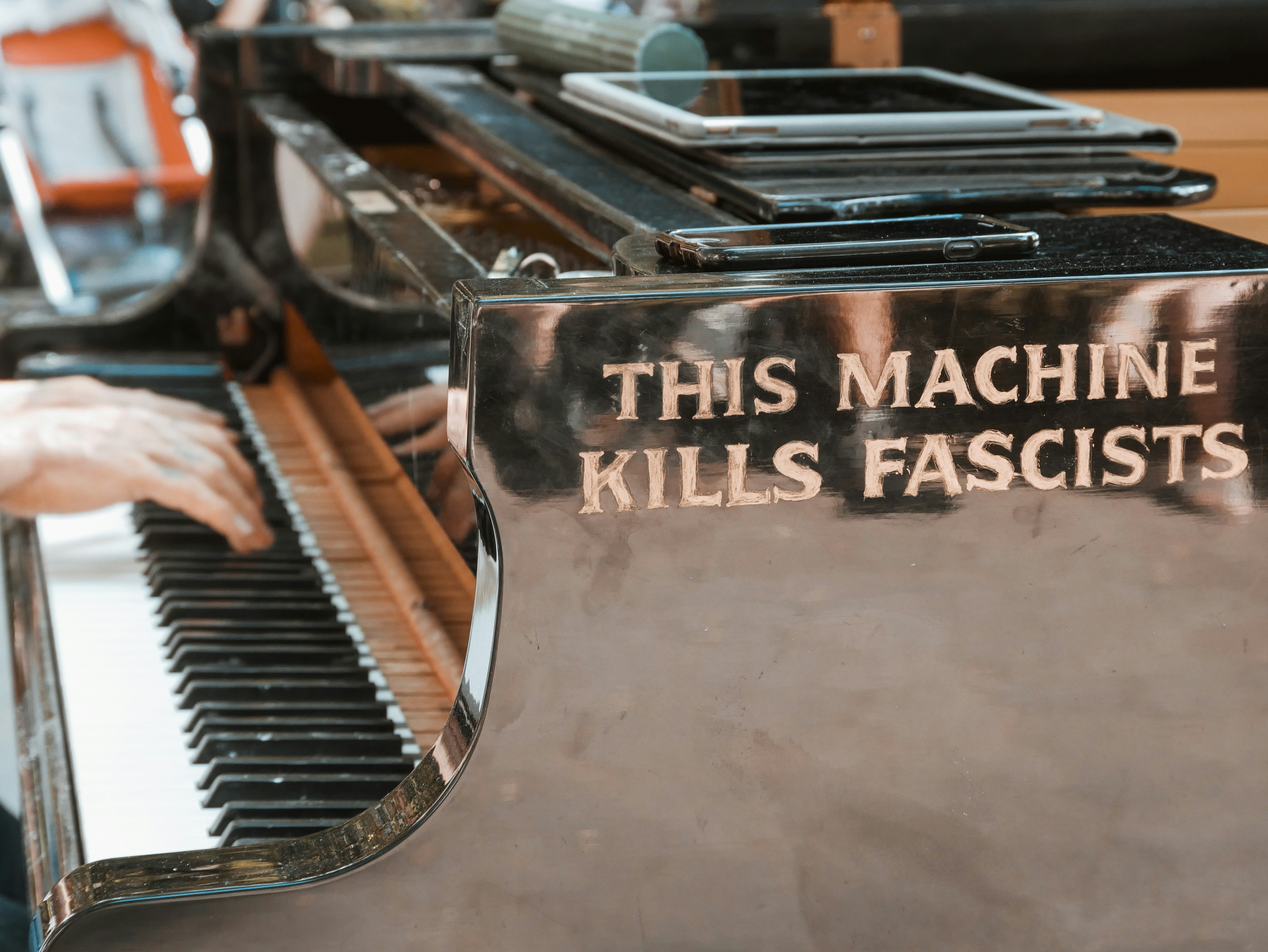 person using white and black upright piano, Found on the side of the grand piano in Washington Square Park