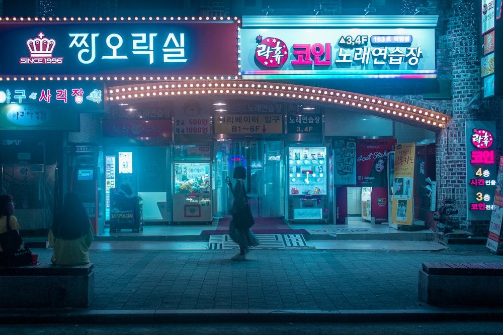 person carrying bag walking in front of store