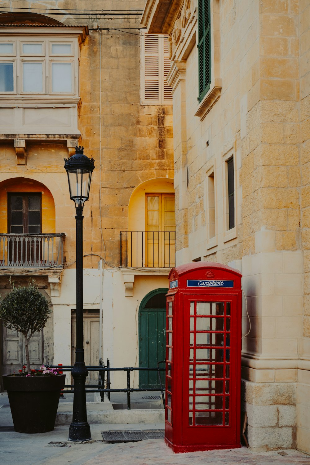 red telephone booth near lantern