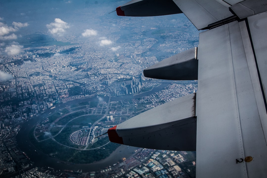 person inside plane taking photo of aerial view of city,