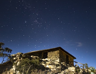 brown and white concrete house on mountain
